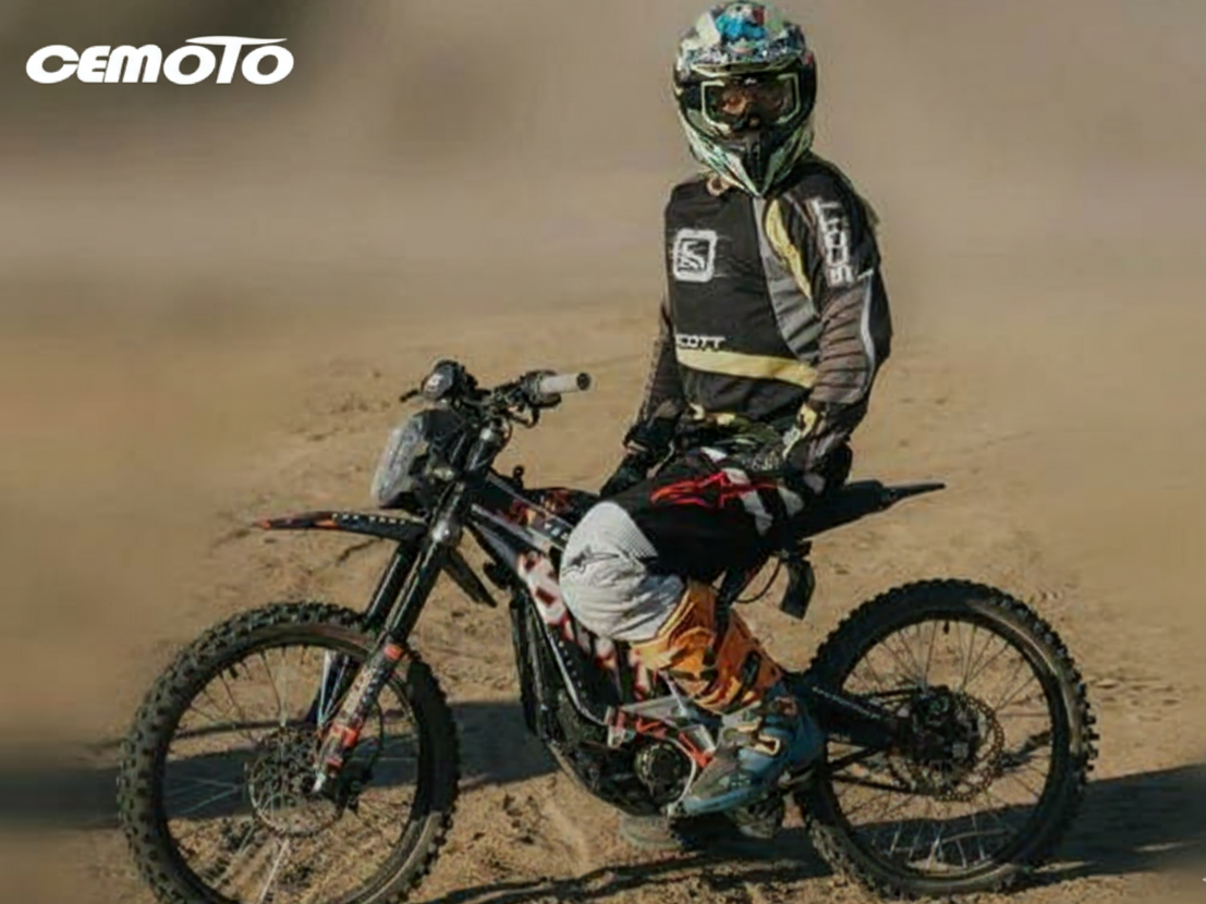 Professional motocross rider on CEMOTO electric dirt bike in desert racing environment