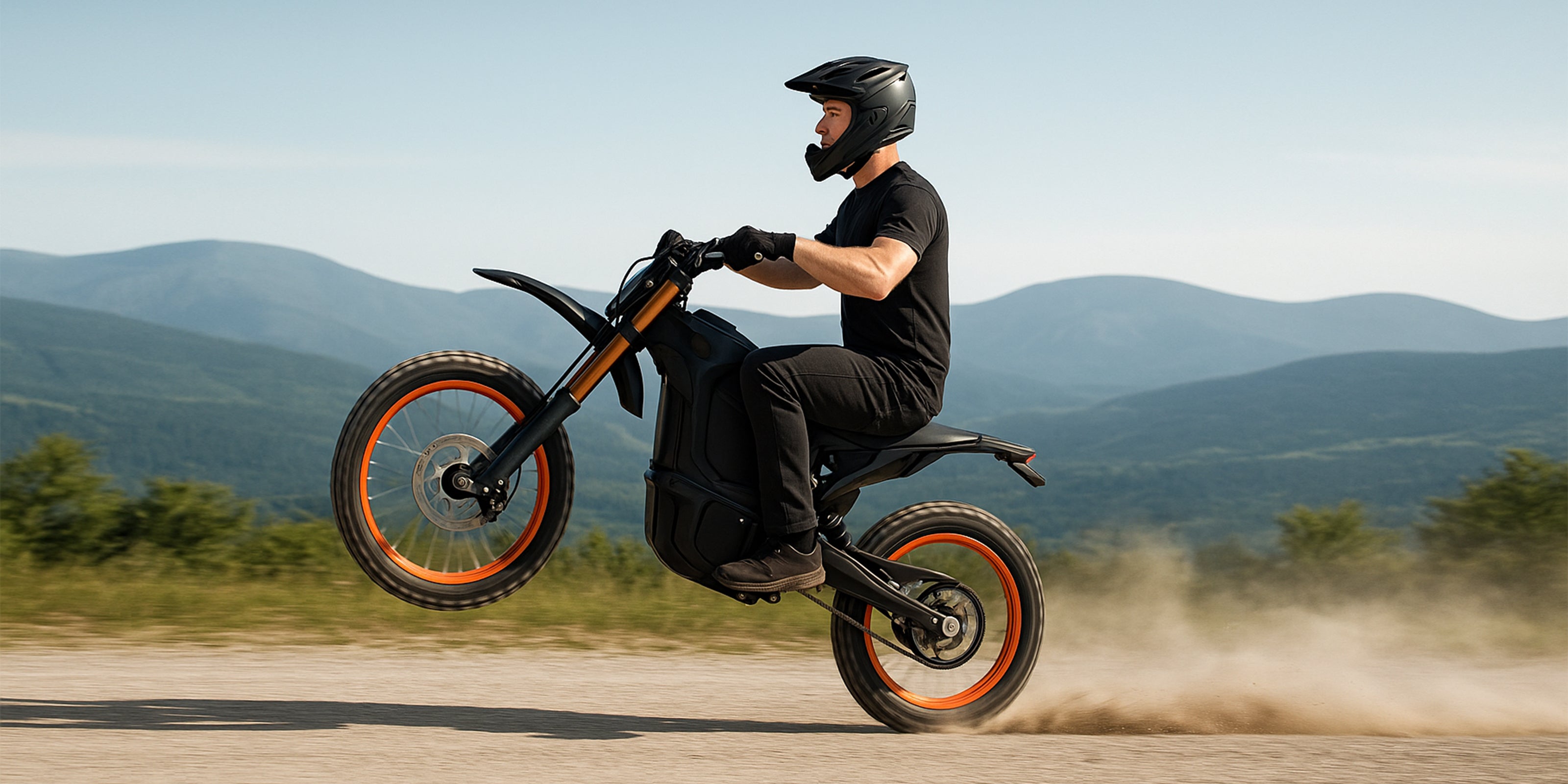 Side view of a rider doing a wheelie on a black electric dirt bike with orange rims on a mountain dirt path. Experience off-road e-bike thrills.