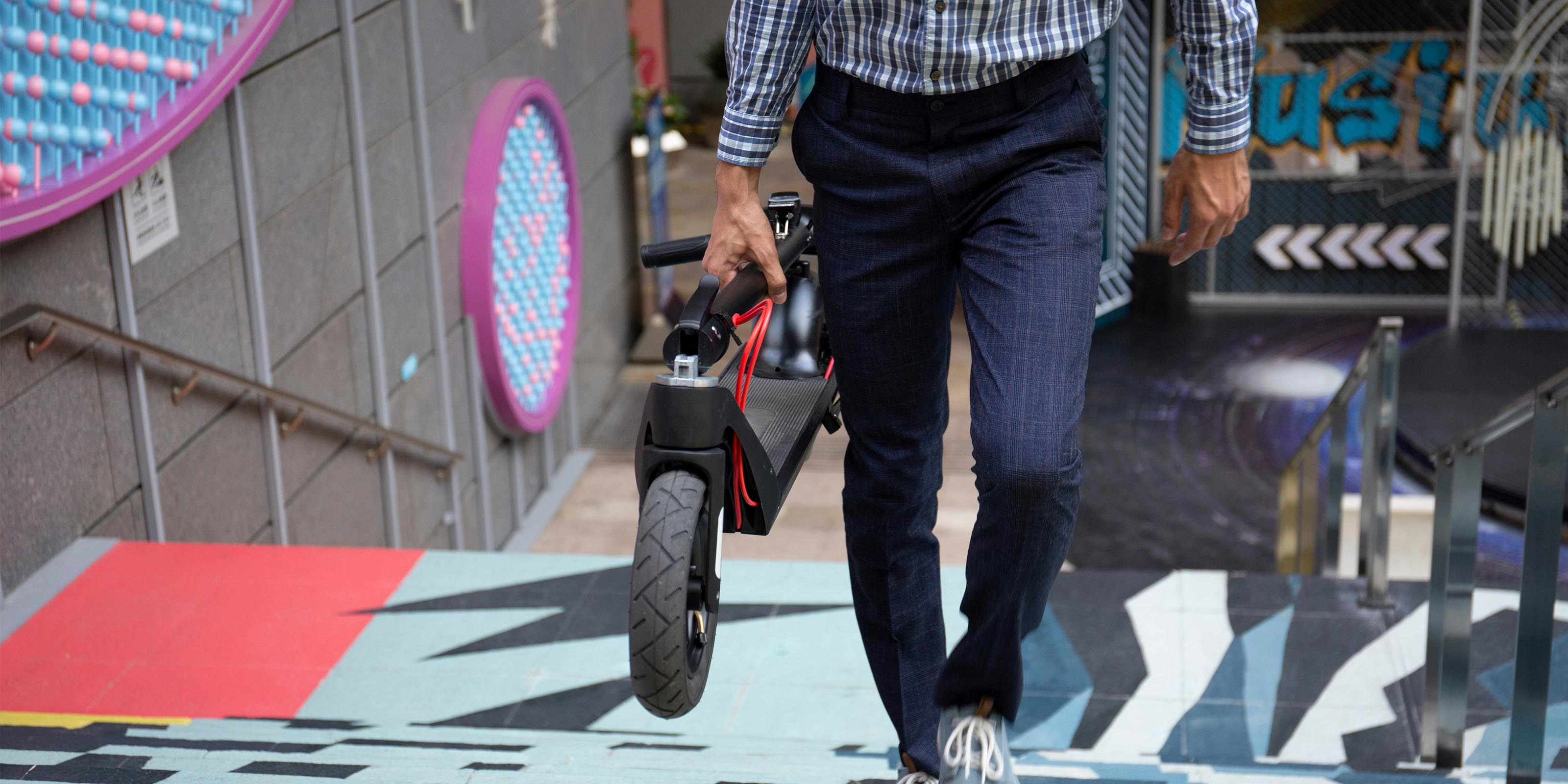 men with a folding electric scooter