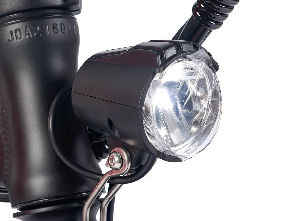 Hero image introducing practical electric bike accessories for everyday commuting, with visibility equipment shown in use on an urban route.